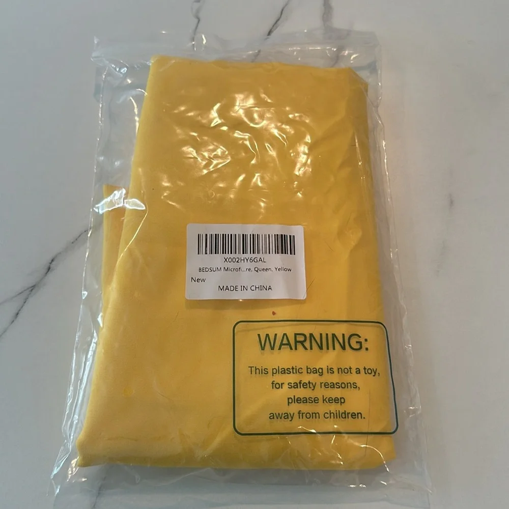 One new in bag yellow queen size pillow case